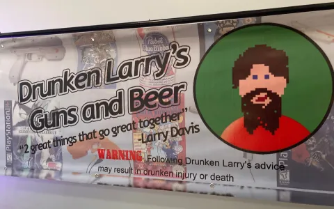A banner reading "Drunken Larry's Guns and Beer - 2 great things that go great together". Also has this warning: "Following Drunken Larry's advice may result in drunken injury or death."